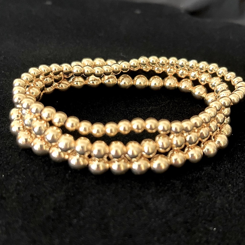 Set of three gold tone bracelets